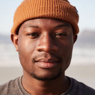 Portrait of a friendly and experienced male fitness mentor smiling gently.